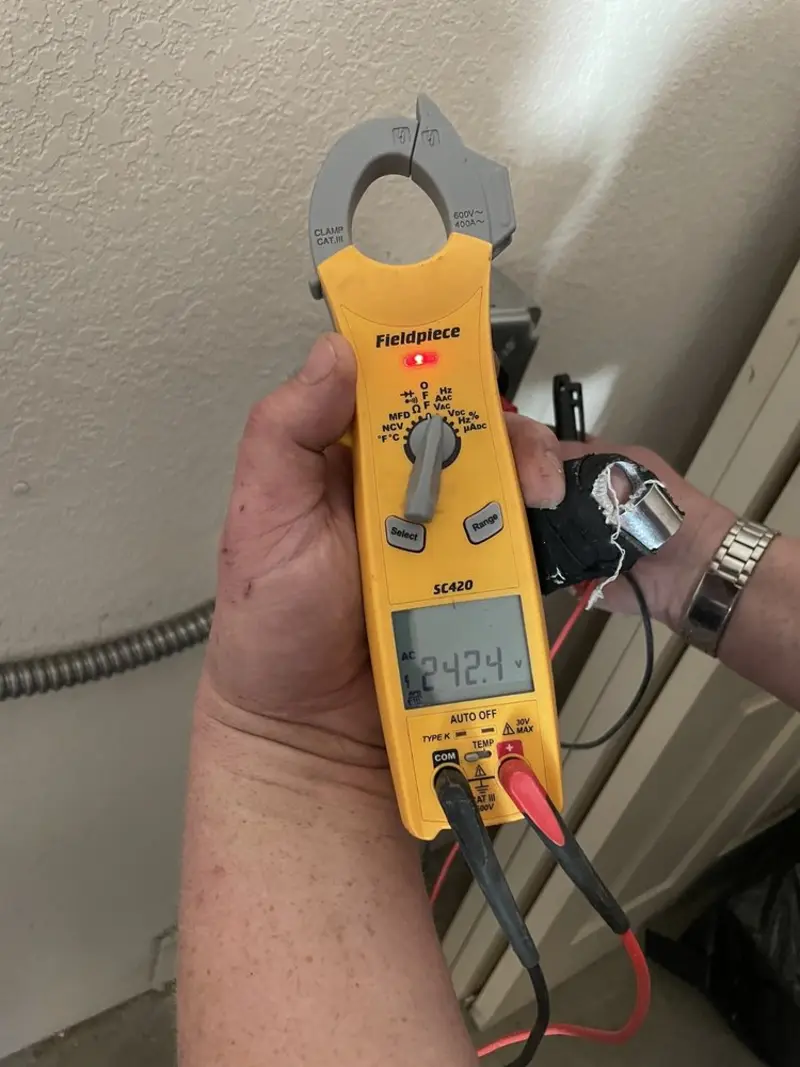 Voltage testing with clamp meter during Whole House Surge Protector in New Hyde Park